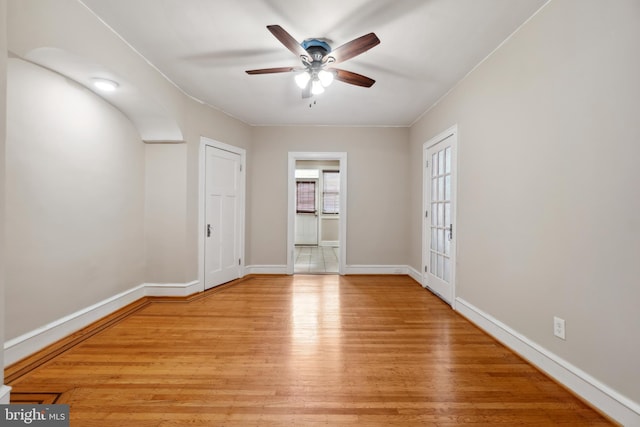 unfurnished room with light wood-type flooring and ceiling fan