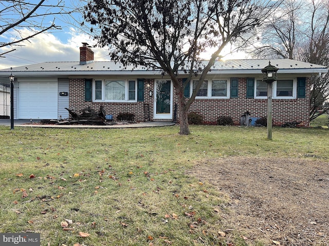 single story home featuring a front yard and a garage