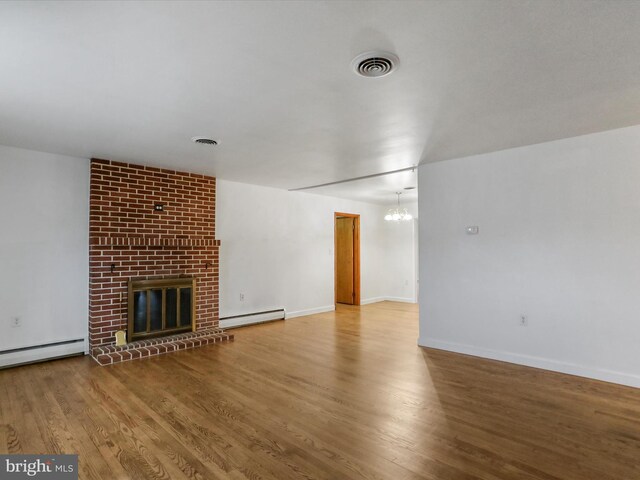 64 W Walter Ave, Greencastle, PA 17225 - unfurnished living room featuring a baseboard radiator, wood finished floors, and a fireplace