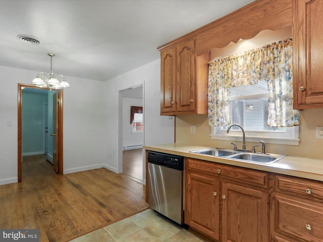 kitchen with pendant lighting, dishwasher, an inviting chandelier, sink, and light hardwood / wood-style flooring