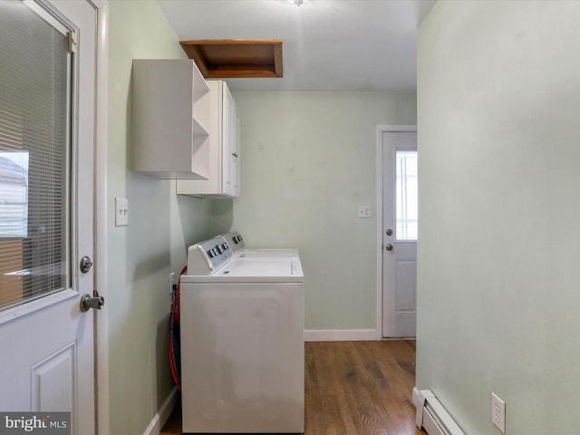 clothes washing area with baseboard heating, washer and dryer, cabinets, and dark hardwood / wood-style floors