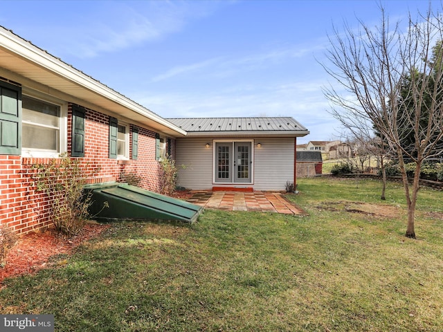 rear view of property with a yard