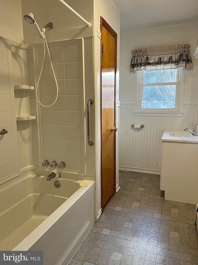 bathroom featuring vanity, shower / bath combination, and wooden walls