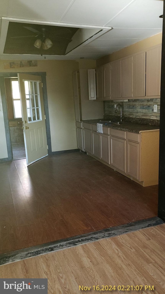 kitchen featuring light brown cabinetry, decorative backsplash, dark hardwood / wood-style flooring, and sink