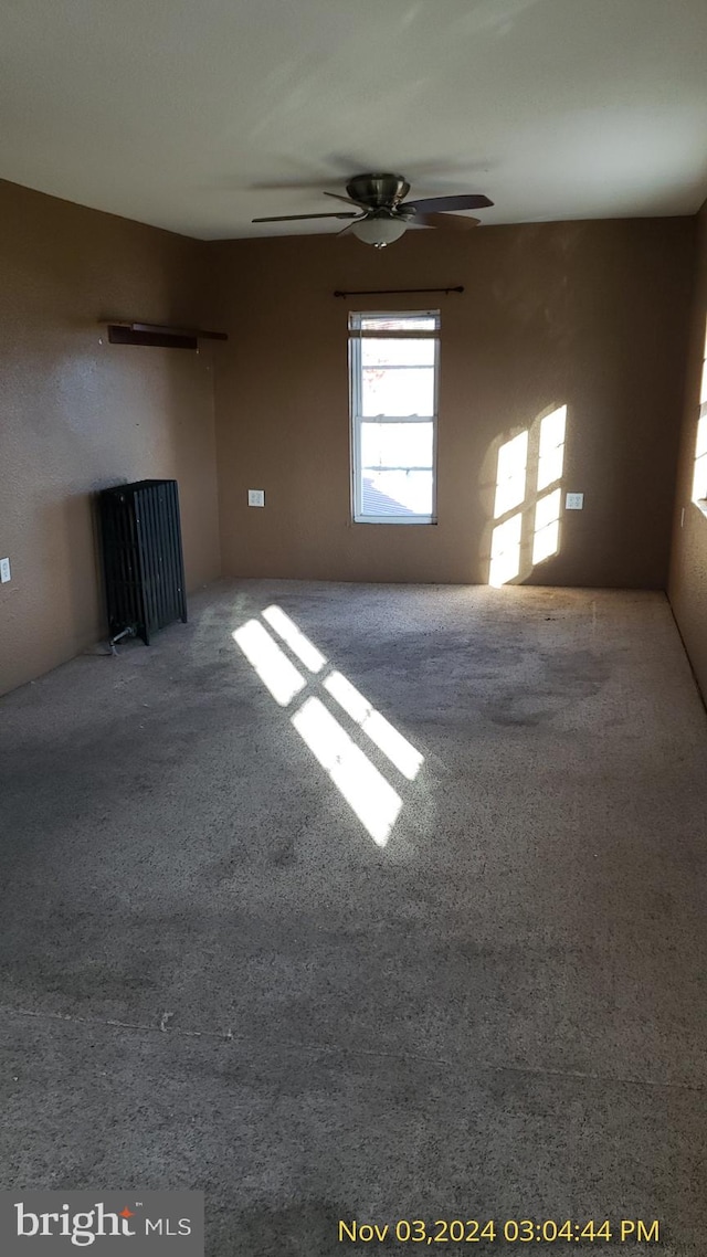 empty room with carpet floors and ceiling fan