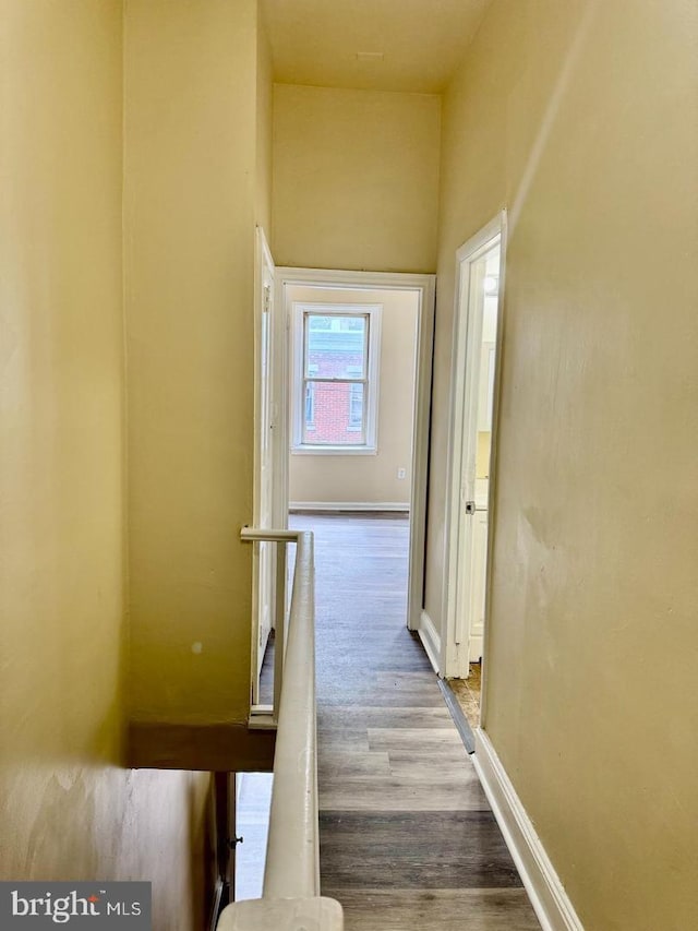 hallway with hardwood / wood-style flooring