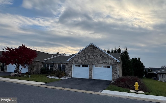 view of front of home featuring a front yard and a garage