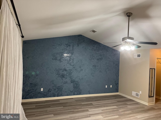 unfurnished room with lofted ceiling, ceiling fan, and wood-type flooring