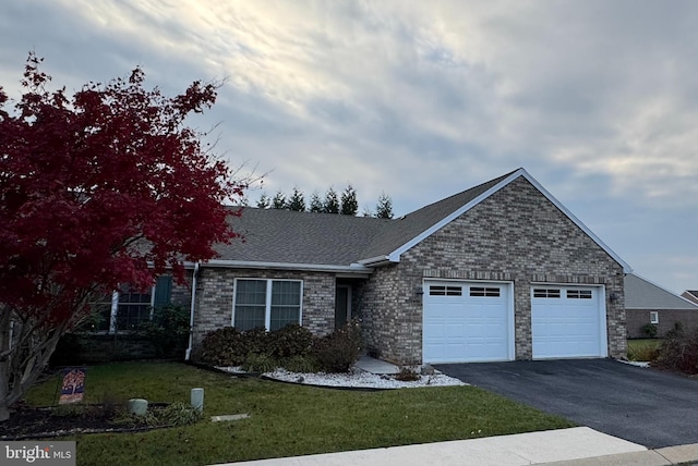 view of front facade featuring a garage and a front lawn