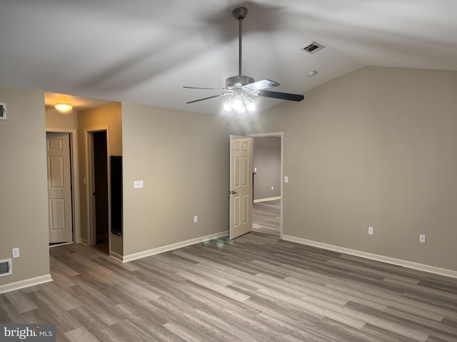 empty room with light hardwood / wood-style floors, ceiling fan, and lofted ceiling