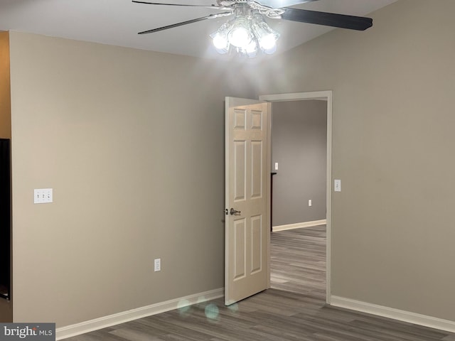 unfurnished room with ceiling fan and dark hardwood / wood-style flooring