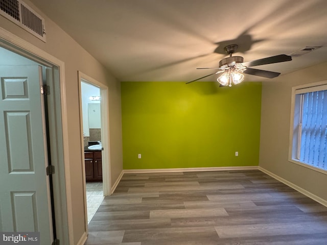 spare room featuring light hardwood / wood-style floors and ceiling fan