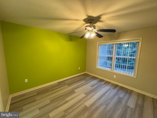 unfurnished room with ceiling fan and hardwood / wood-style flooring