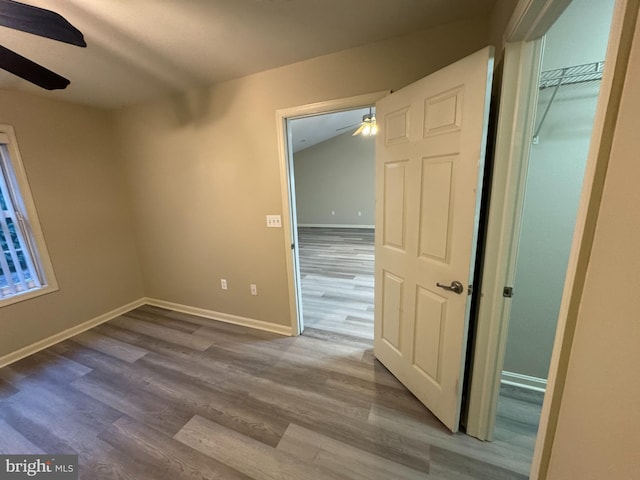 unfurnished room with ceiling fan and hardwood / wood-style flooring