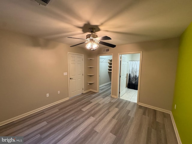 unfurnished room with ceiling fan and wood-type flooring