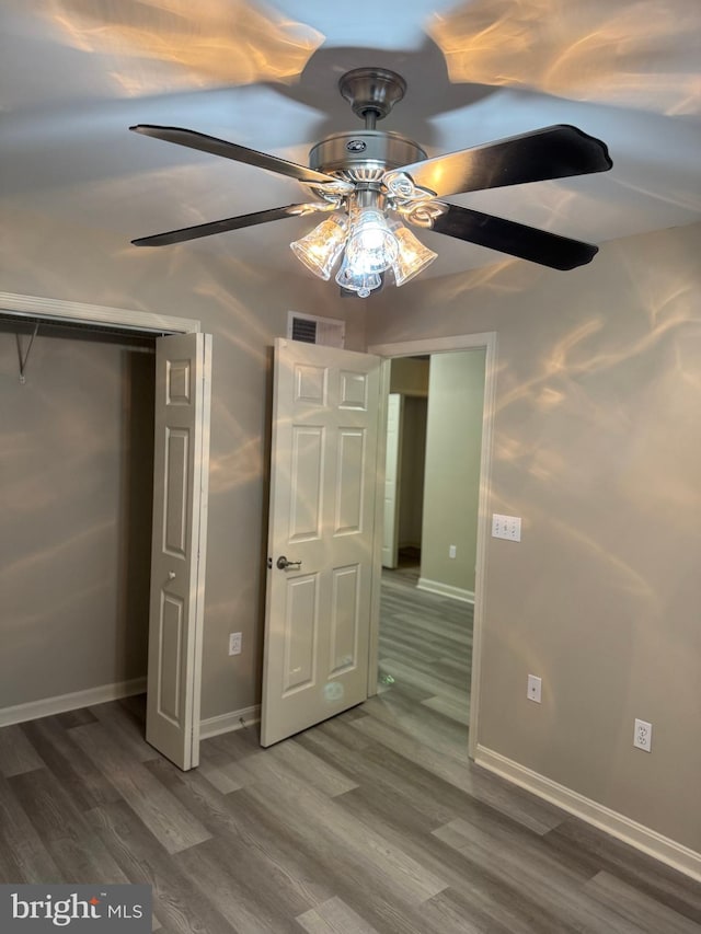 unfurnished bedroom featuring ceiling fan and wood-type flooring