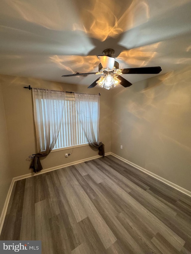 spare room featuring hardwood / wood-style floors and ceiling fan