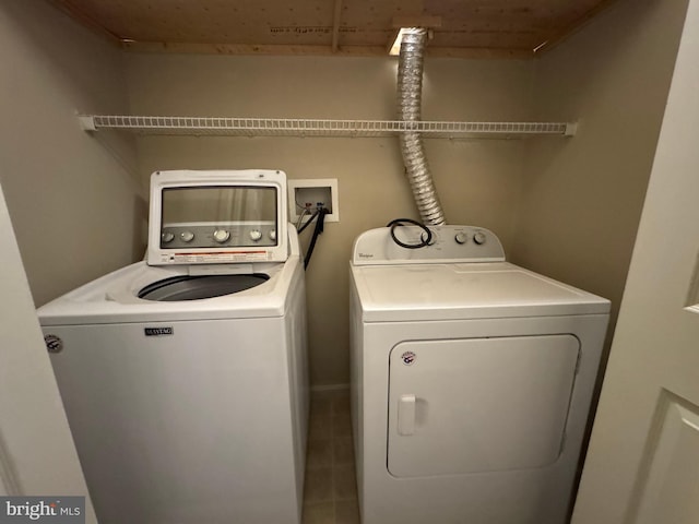 clothes washing area with washing machine and dryer