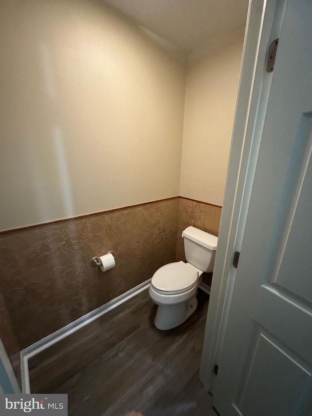 bathroom with wood-type flooring and toilet