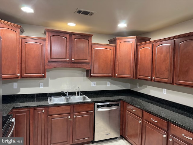 kitchen featuring dark stone countertops, sink, and stainless steel appliances