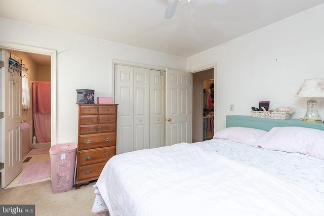 bedroom with ceiling fan, a closet, and light colored carpet