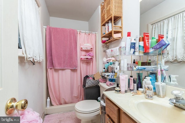 bathroom with vanity, curtained shower, and toilet