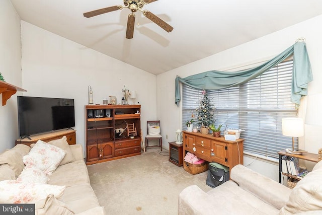 carpeted living room with ceiling fan and lofted ceiling