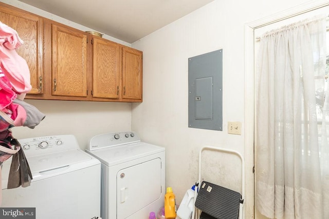 laundry room with separate washer and dryer, electric panel, and cabinets