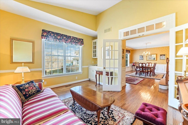 living room with hardwood / wood-style floors and a notable chandelier