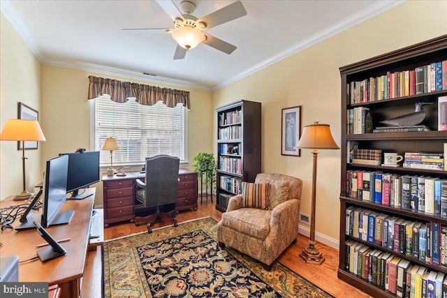 office area featuring ceiling fan, ornamental molding, and hardwood / wood-style floors