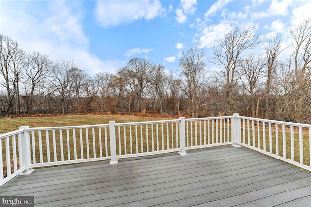 wooden terrace featuring a yard