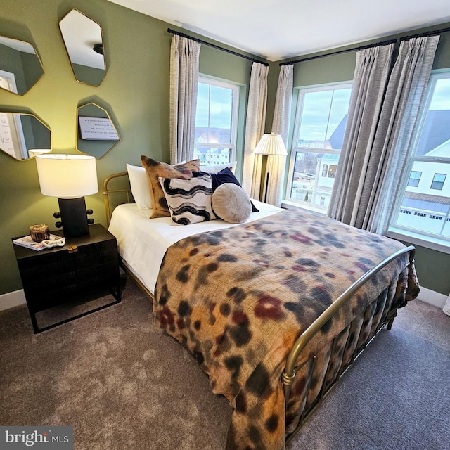 carpeted bedroom featuring multiple windows