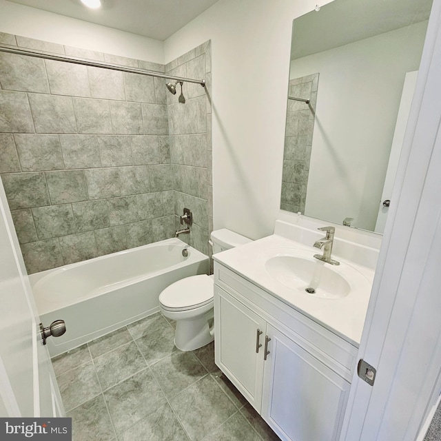 full bathroom featuring tile patterned floors, toilet, vanity, and tiled shower / bath