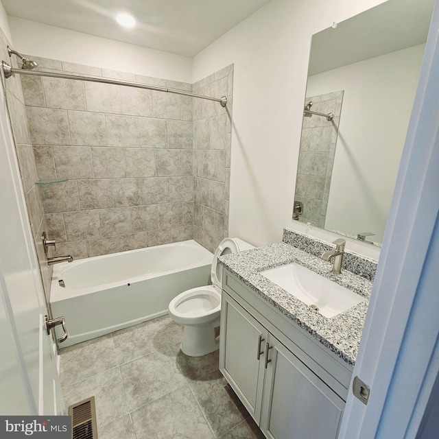 full bathroom featuring tile patterned flooring, vanity, toilet, and tiled shower / bath