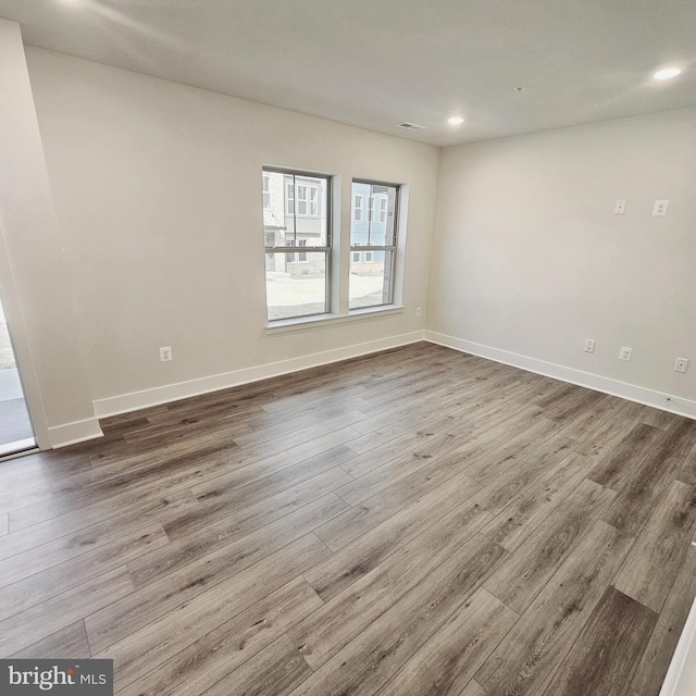 spare room featuring hardwood / wood-style flooring