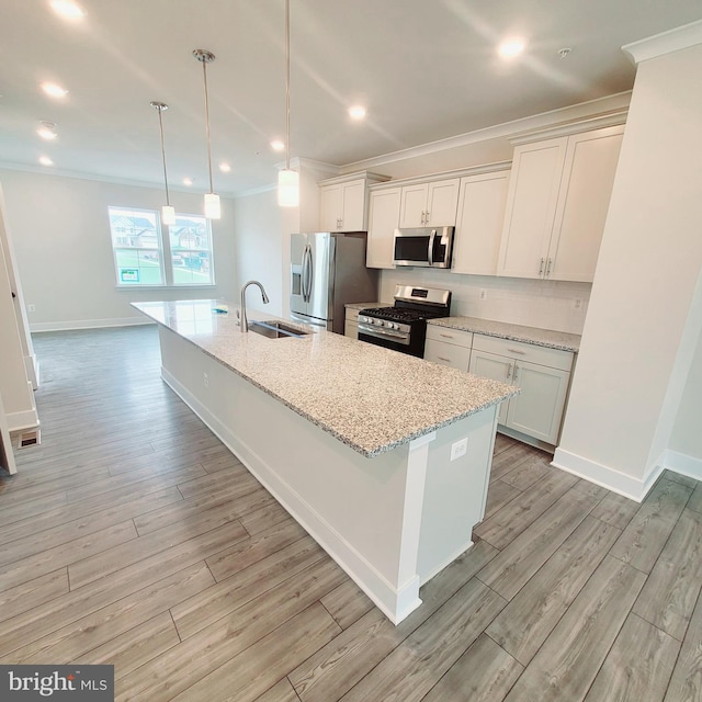 kitchen with sink, white cabinets, stainless steel appliances, and light hardwood / wood-style floors