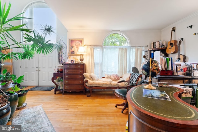 home office with hardwood / wood-style floors and ornamental molding