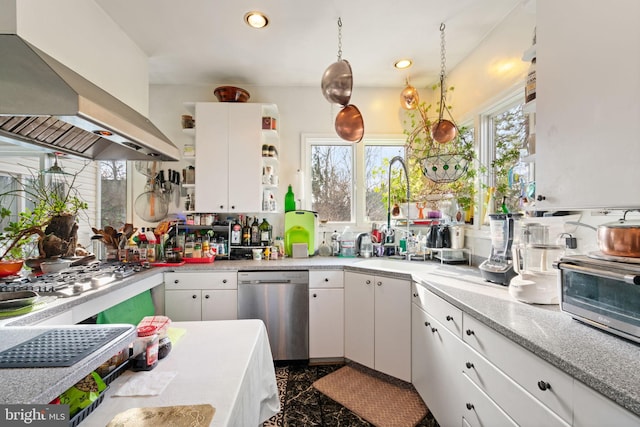 kitchen featuring hanging light fixtures, light stone counters, white cabinetry, stainless steel appliances, and extractor fan