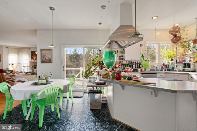 kitchen with white cabinets, island range hood, and pendant lighting