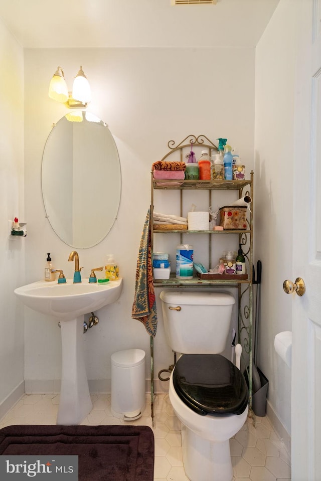 bathroom with tile patterned flooring and toilet