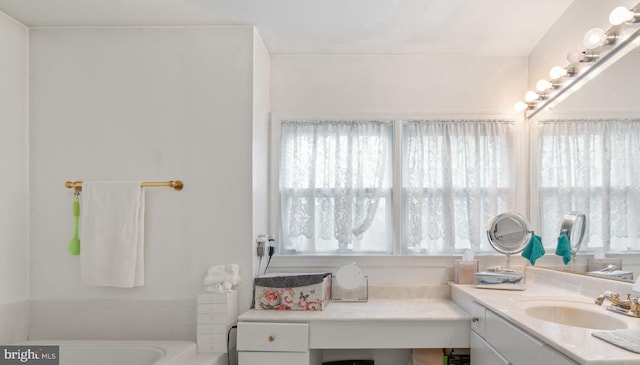 bathroom featuring vanity and a bath