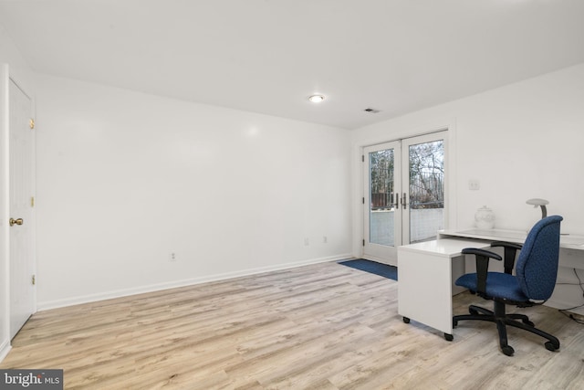 office area with light wood-type flooring and french doors