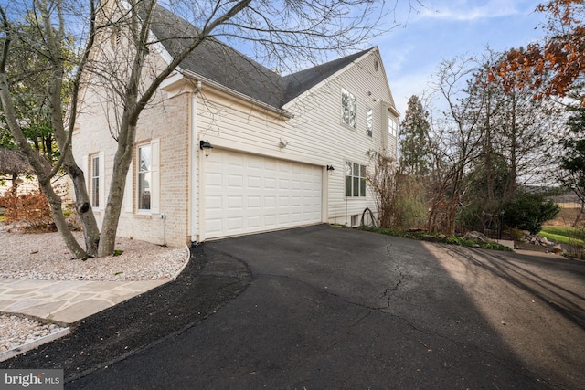 view of side of home featuring a garage