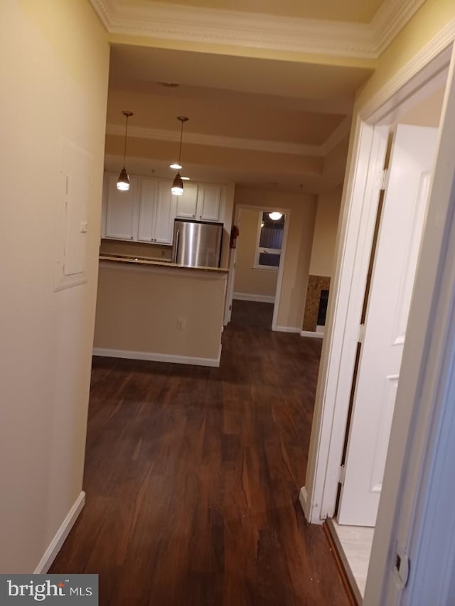 corridor featuring ornamental molding and dark wood-type flooring