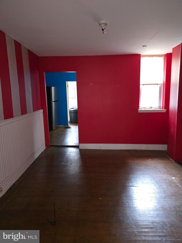 spare room featuring dark hardwood / wood-style flooring