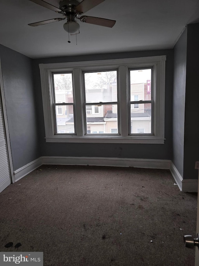 unfurnished room with carpet and ceiling fan