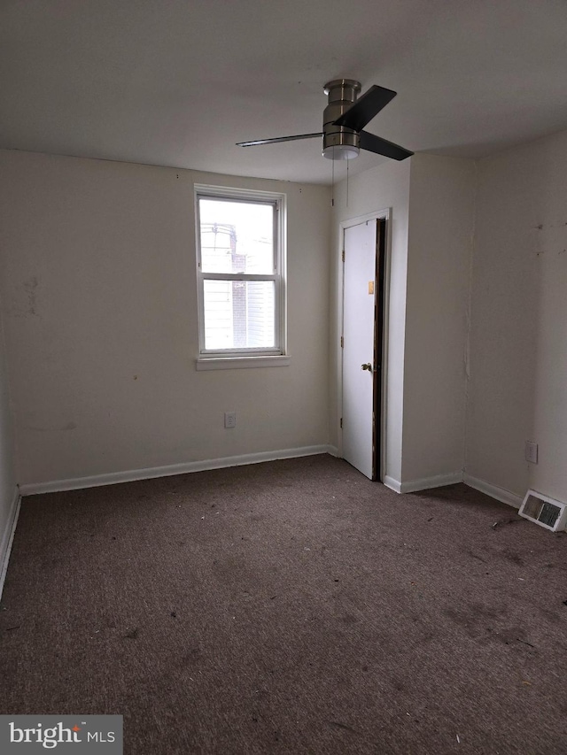 unfurnished room featuring ceiling fan and carpet floors