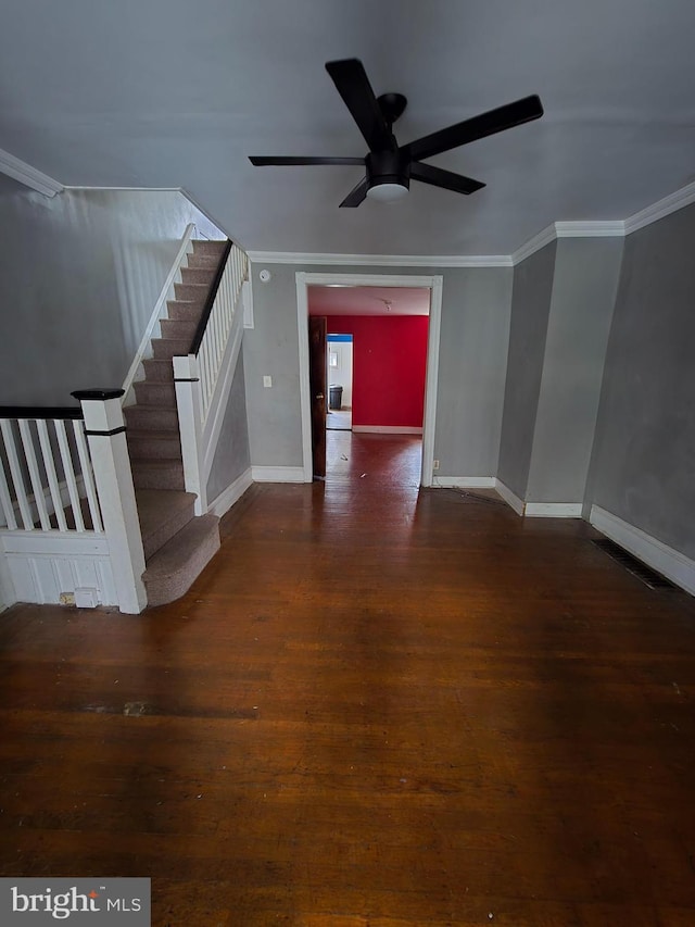 unfurnished living room featuring dark hardwood / wood-style floors, ceiling fan, and crown molding