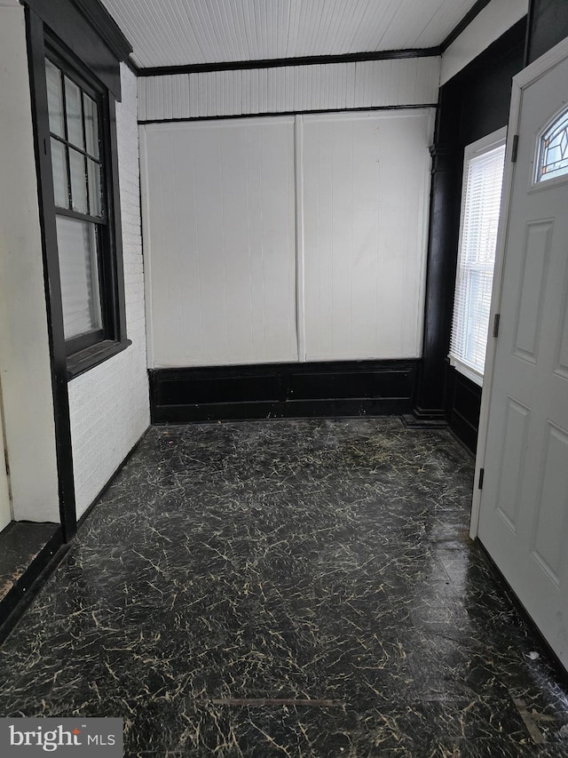 entrance foyer featuring wood walls