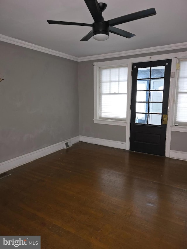 entrance foyer with ceiling fan, crown molding, and dark wood-type flooring